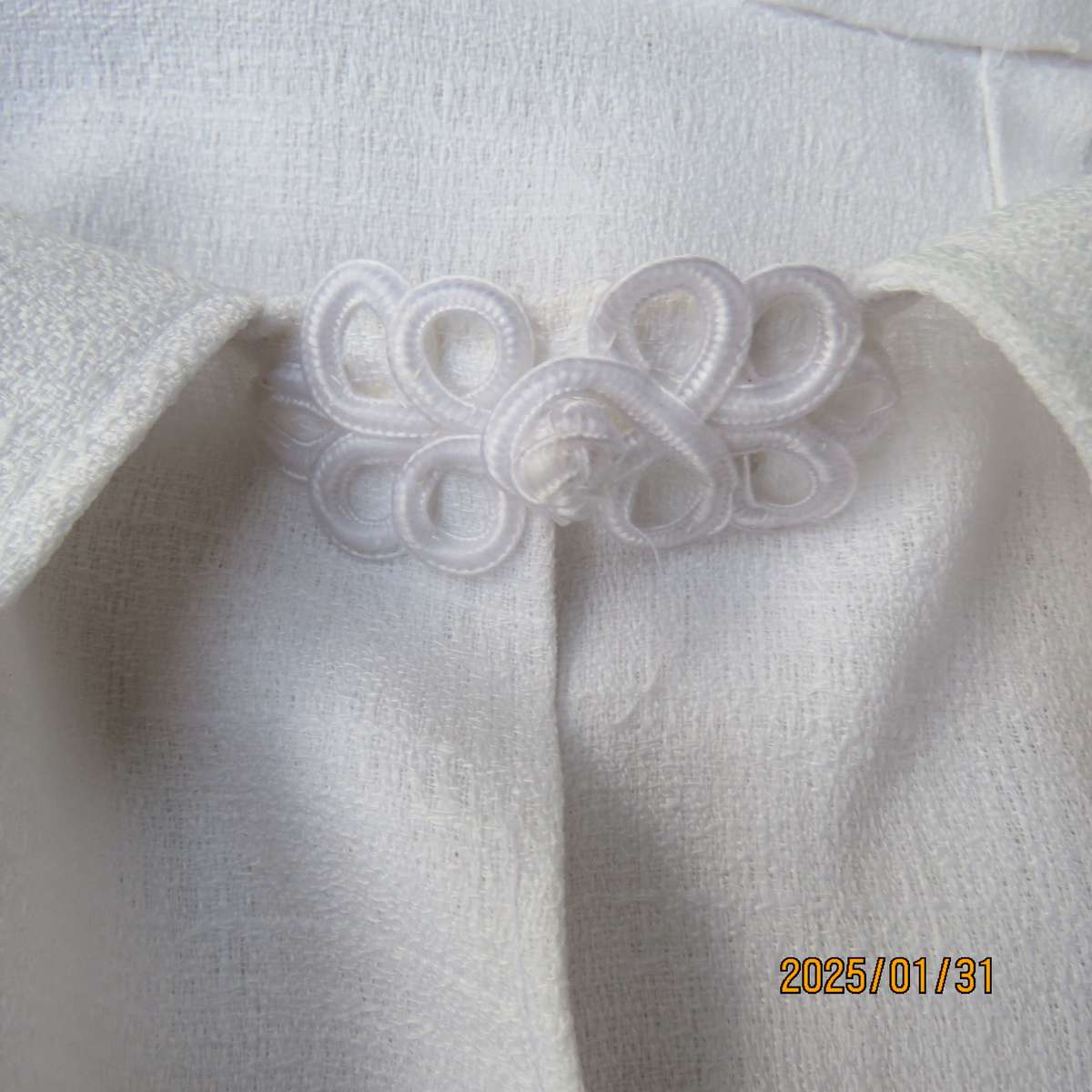 Textured polyester white long cuffed sleeve wide cut open jacket. One button-loop closure. Size 50.