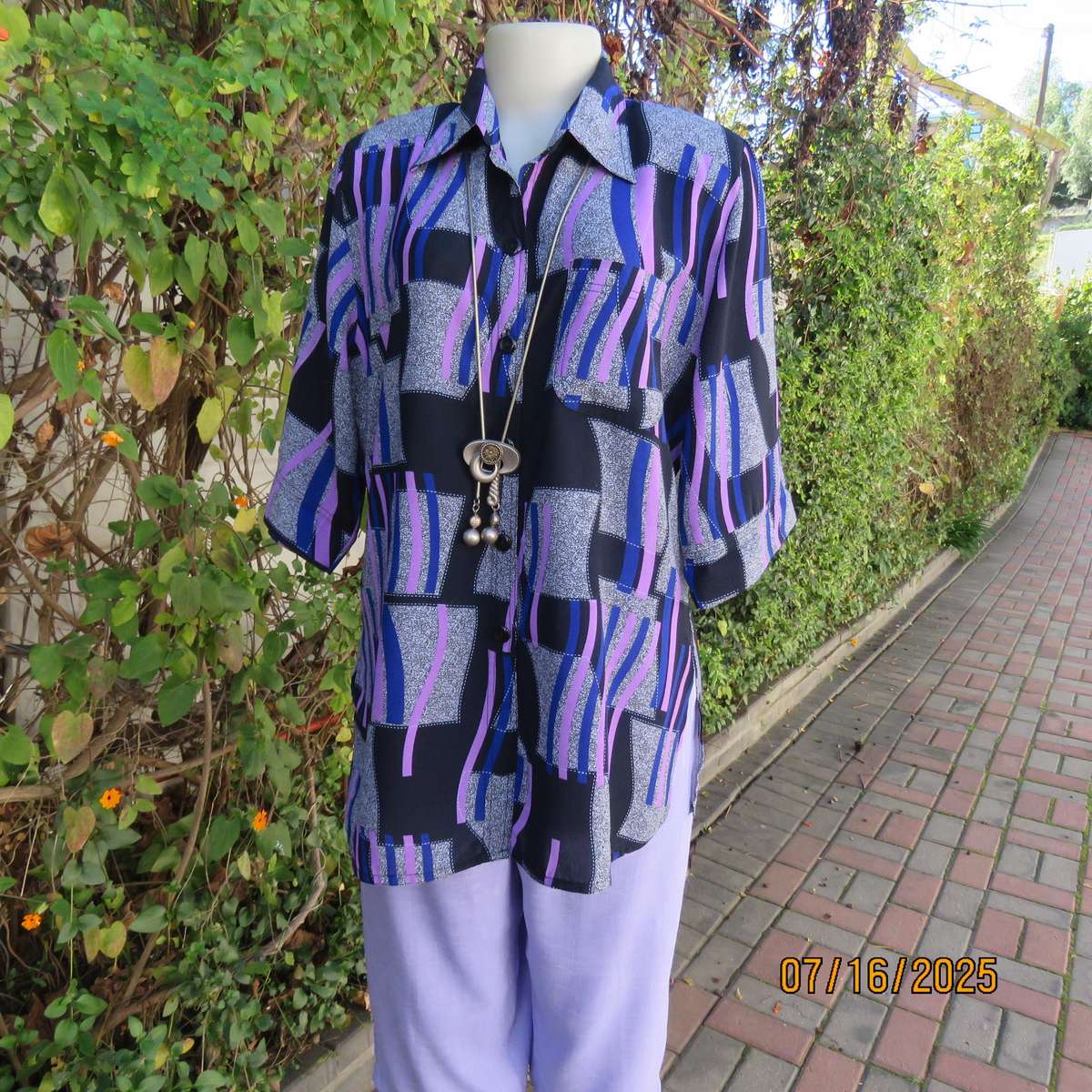 Geometric print button down top in black-lilac-blue and grey. Open collar. Size 40