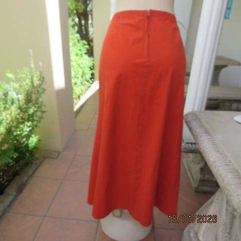 Burnt orange uniquely paneled A-line ankle skirt in 100% cotton. Size 38