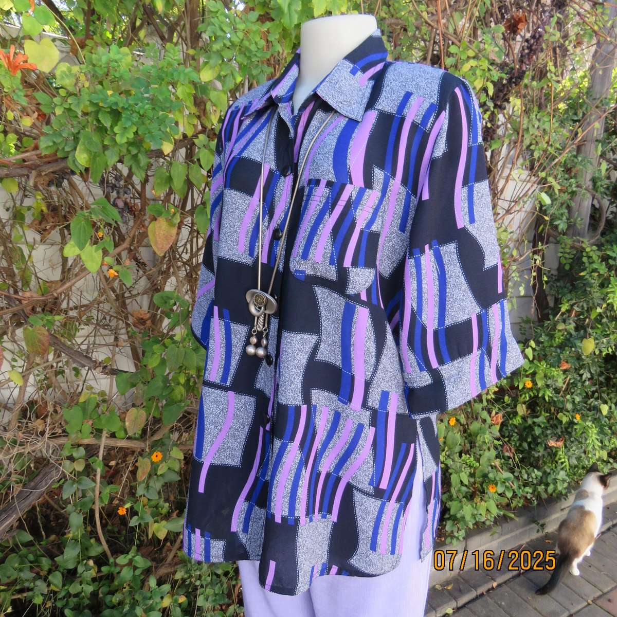 Geometric print button down top in black-lilac-blue and grey. Open collar. Size 40
