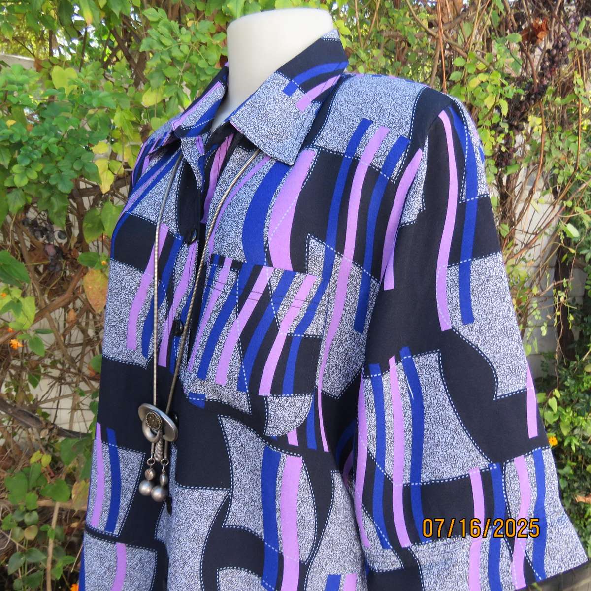 Geometric print button down top in black-lilac-blue and grey. Open collar. Size 40
