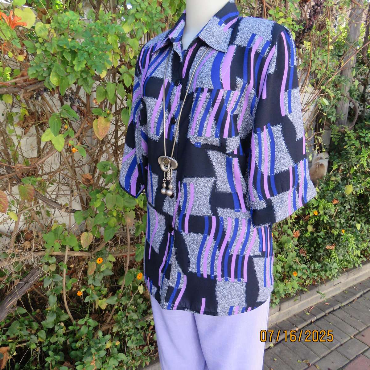 Geometric print button down top in black-lilac-blue and grey. Open collar. Size 40