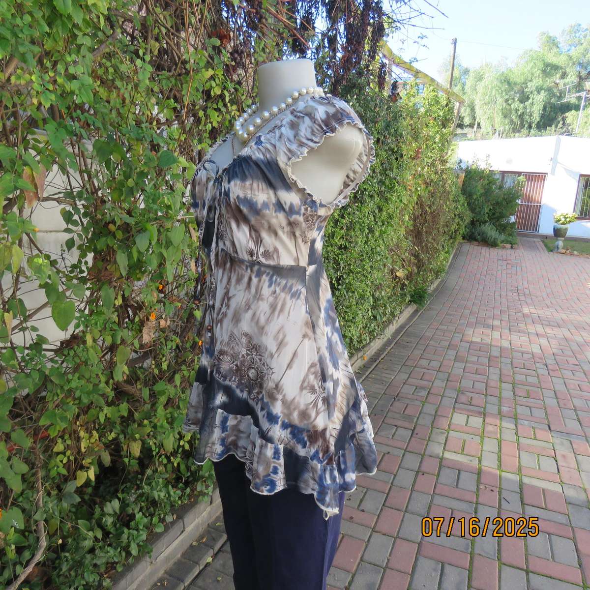 NEWS high-low empire style lined sheer polyester top in blue-cream and brown print. Size 34