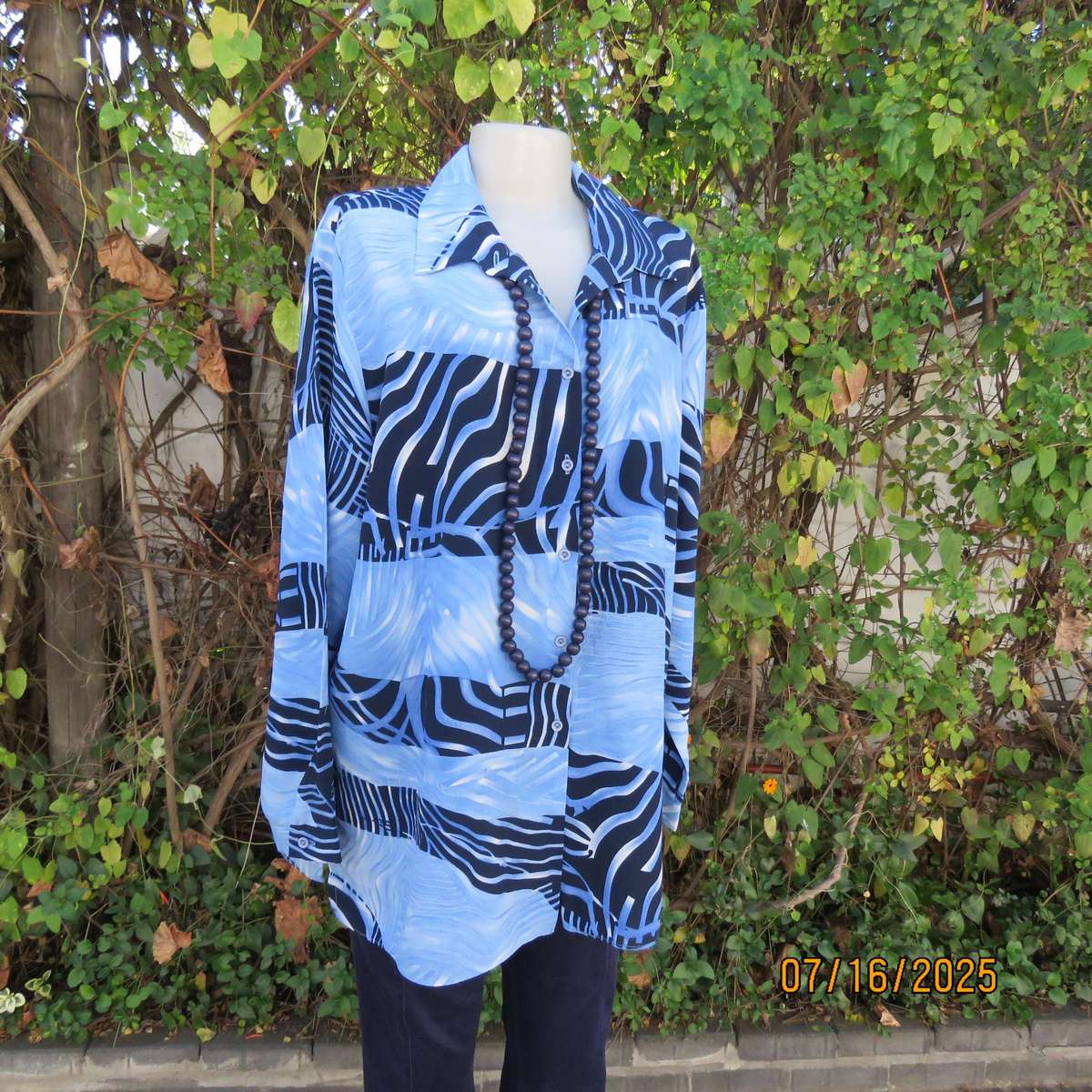 DELSWA long sleeve button down top in shades of blue with animal print. Size 44