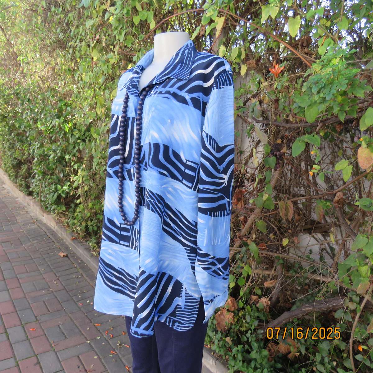 DELSWA long sleeve button down top in shades of blue with animal print. Size 44