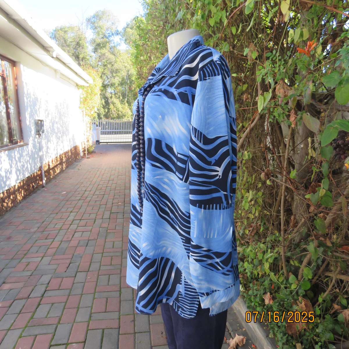 DELSWA long sleeve button down top in shades of blue with animal print. Size 44