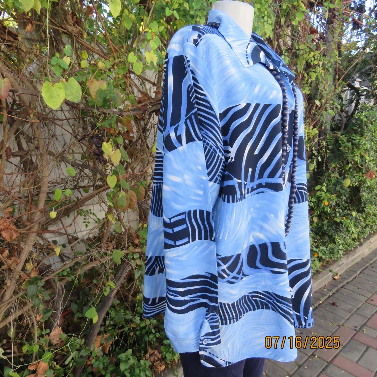 DELSWA long sleeve button down top in shades of blue with animal print. Size 44