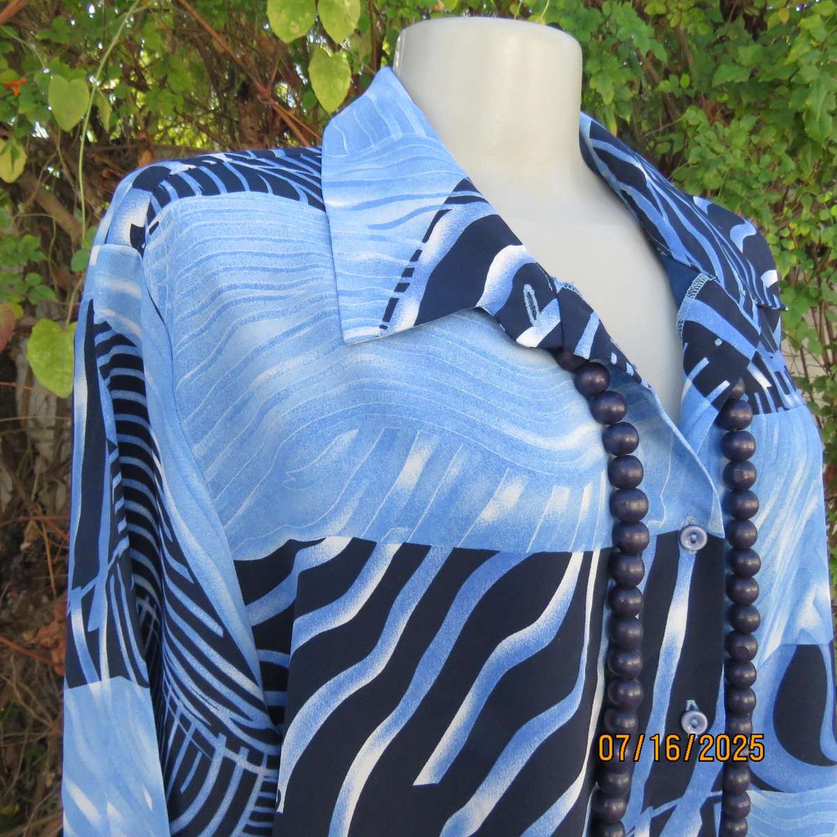 DELSWA long sleeve button down top in shades of blue with animal print. Size 44