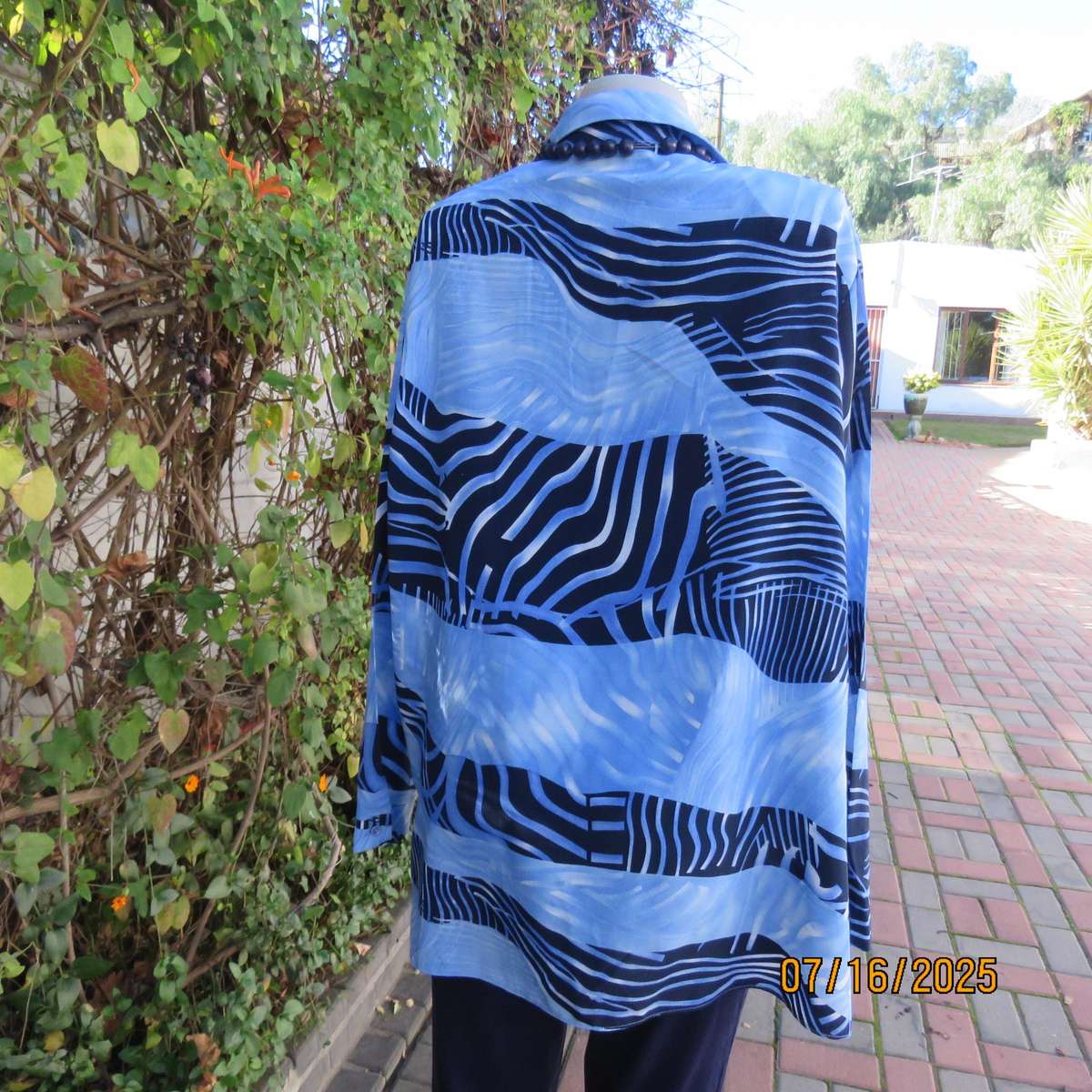 DELSWA long sleeve button down top in shades of blue with animal print. Size 44