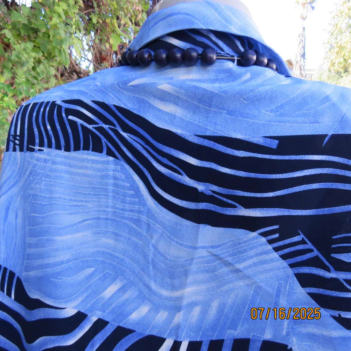 DELSWA long sleeve button down top in shades of blue with animal print. Size 44