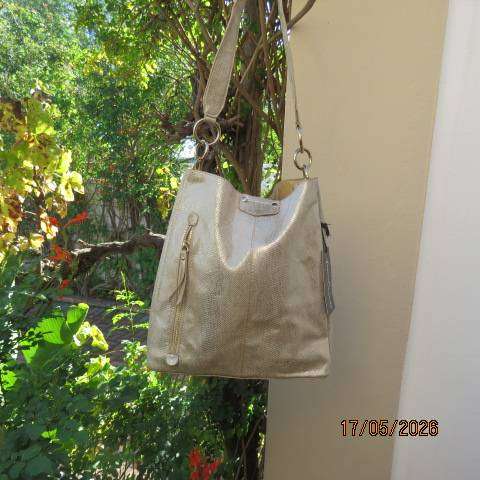 Miss Cassidy gold shoulder bag with gold buckle decoration and vertical front zip
