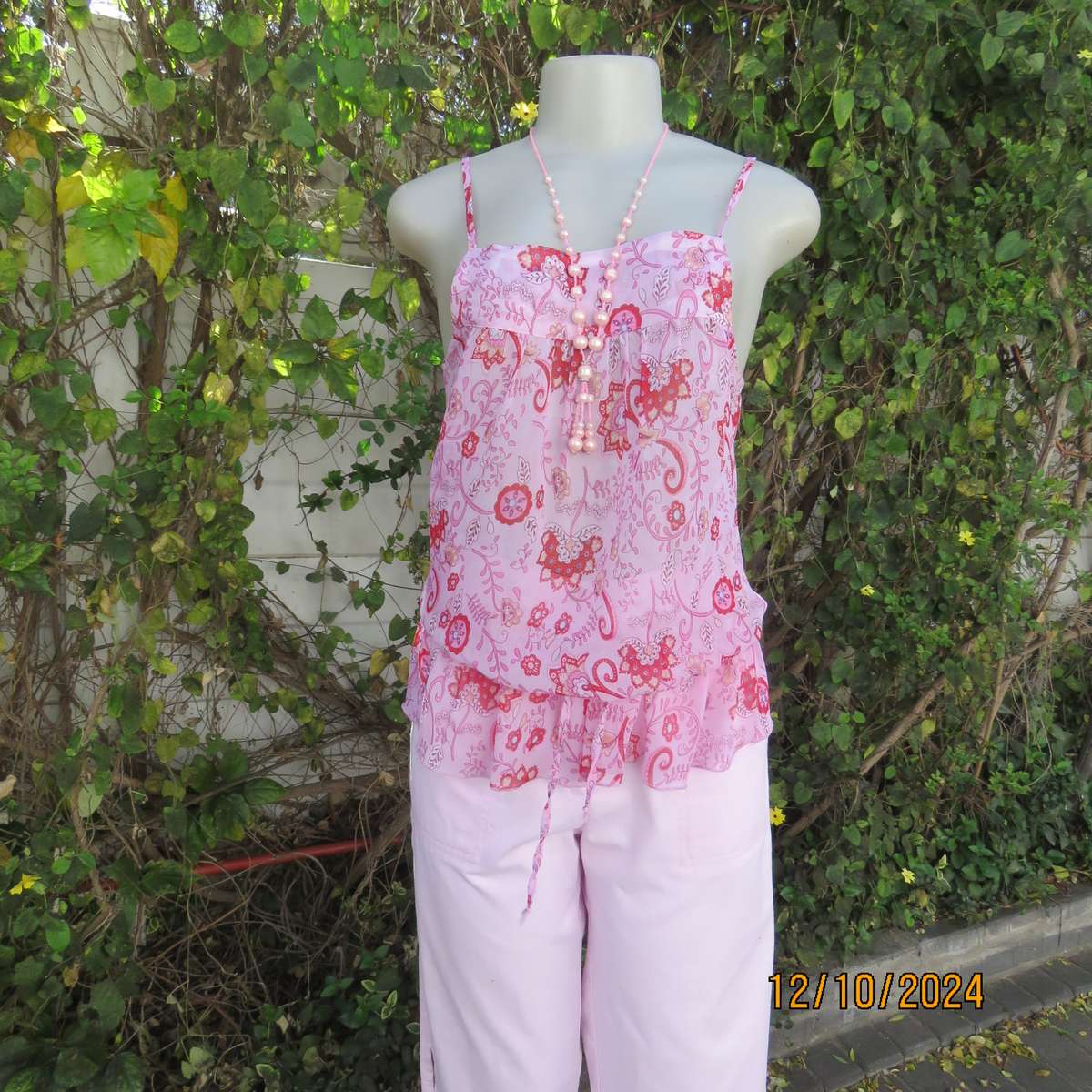 Light pink with red pattern strappy creased polyester top. Size 34.