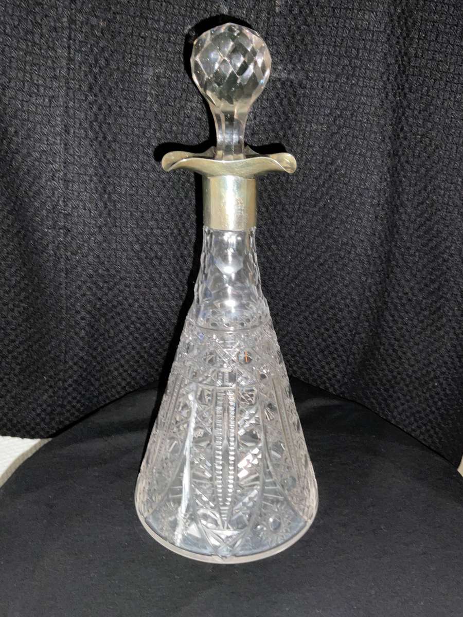 A stunning antique cut glass and silver decanter