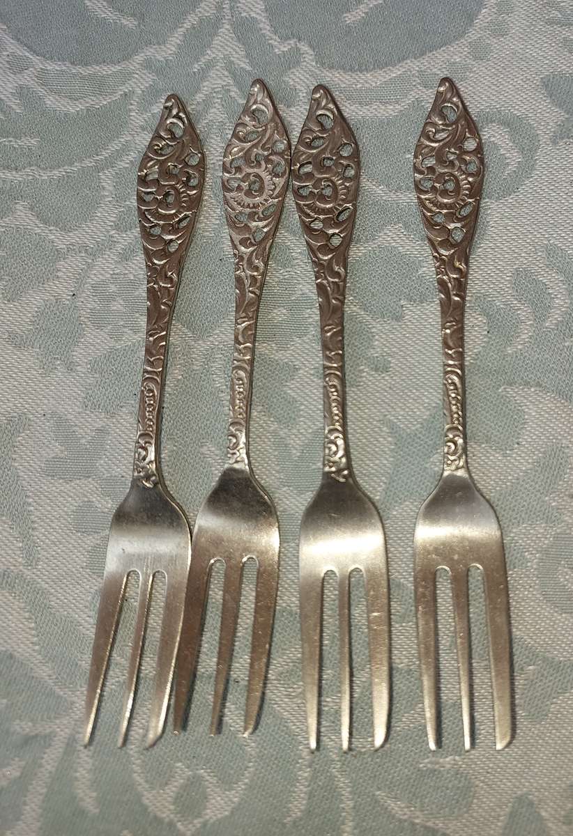 A VINTAGE SET OF COCKTAIL FORKS SOLD AS IS