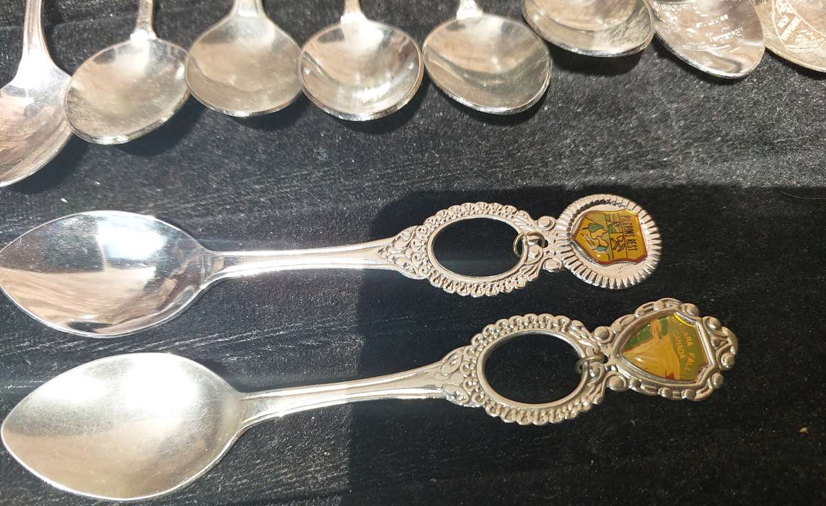 A COLLECTION OF 15 ORNATE MEMORABILIA SPOON