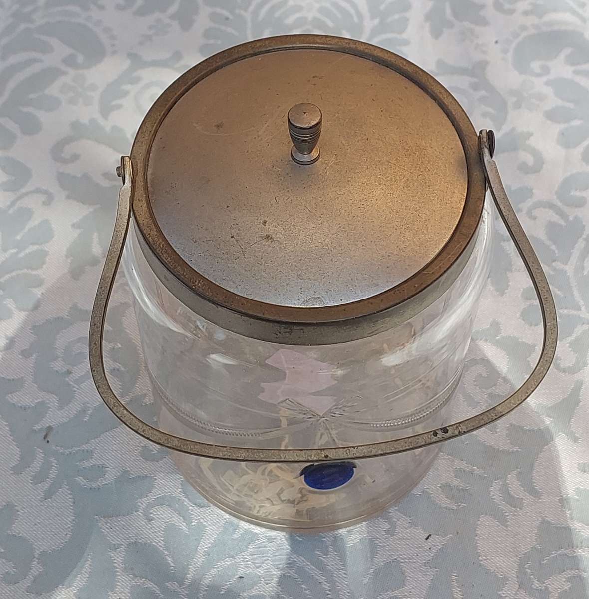 A VINTAGE CUT GLASS ICE BUCKET WITH A SILVER PLATED LID AND HANDLE