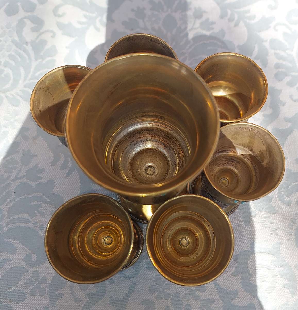 A VINTAGE BRASS KIDDUSH SET