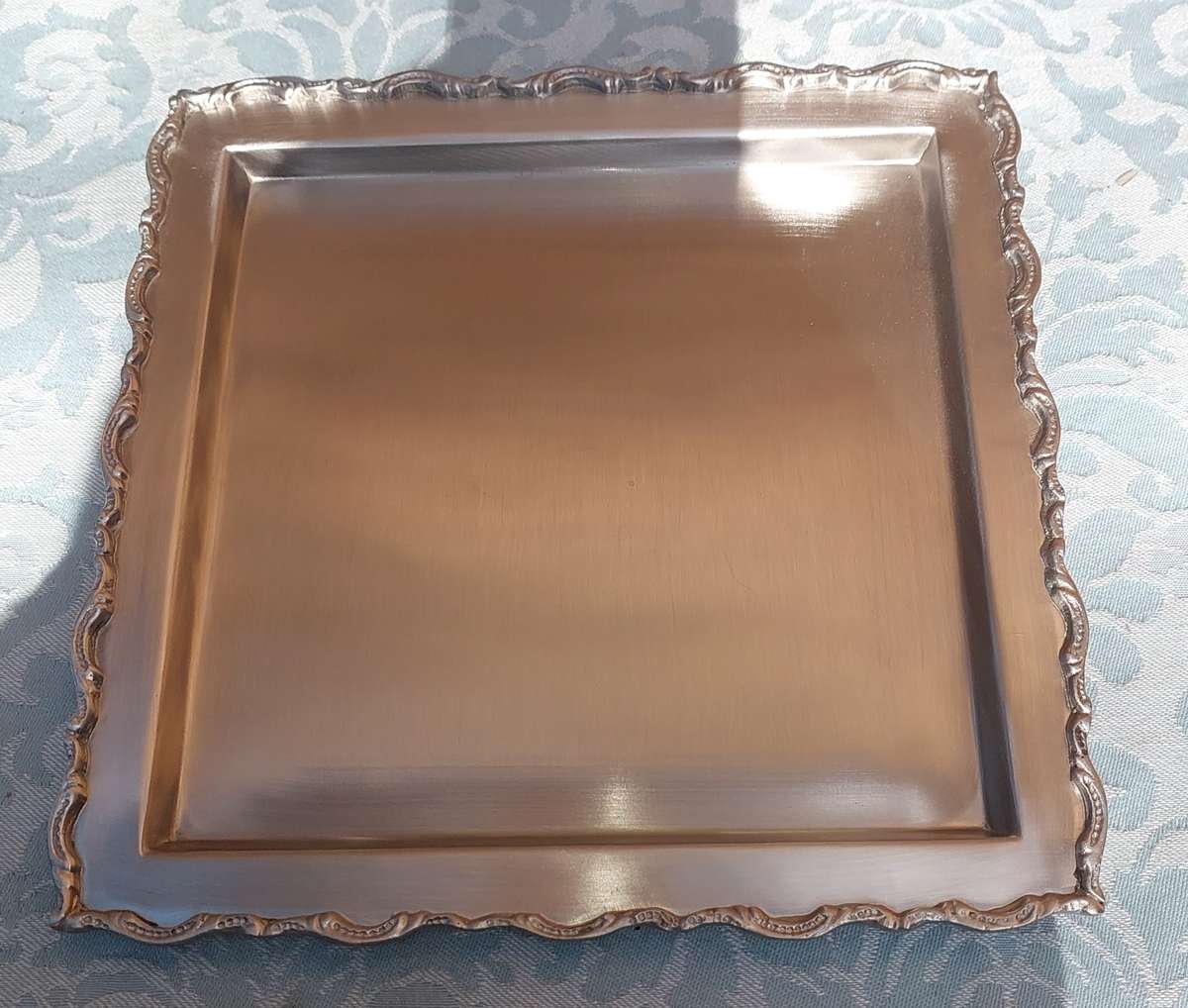 A SQUARE STAINLESS STEEL SERVING TRAY