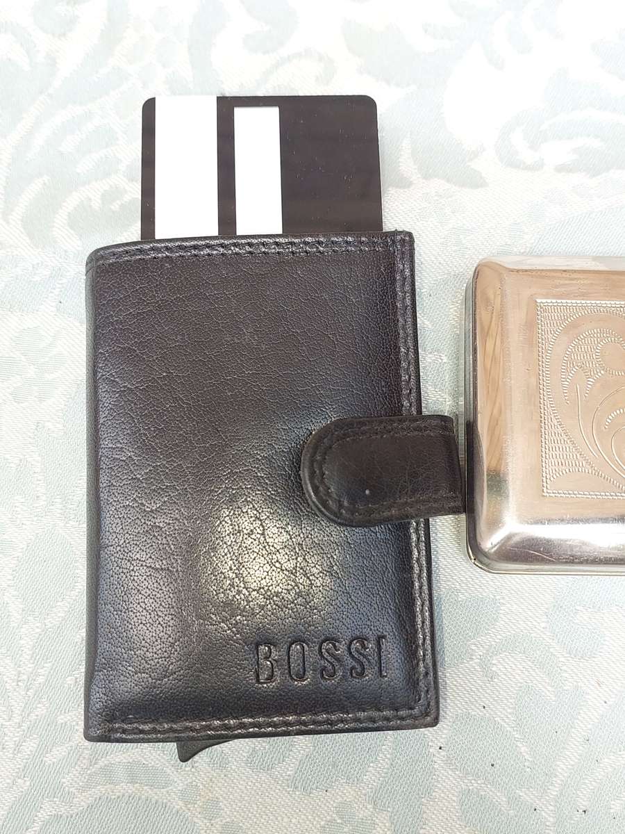 A LEATHER BOSS CREDIT CARD HOLDER AND TWO TRINKETS SOLD AS IS