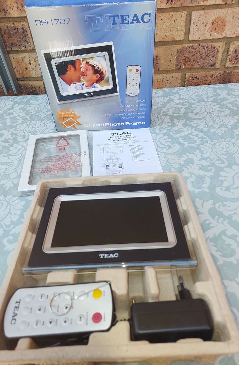 A TEAC DIGITAL PHOTO FRAME WITH ALL THE PAPERWORK SOLD AS IS NOT TESTED