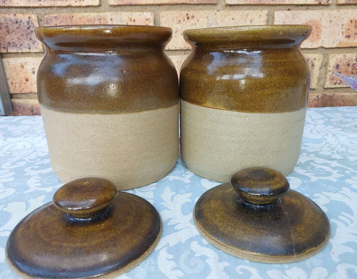 A PAIR OF STONEWARE STORAGE JARS SOLD AS IS