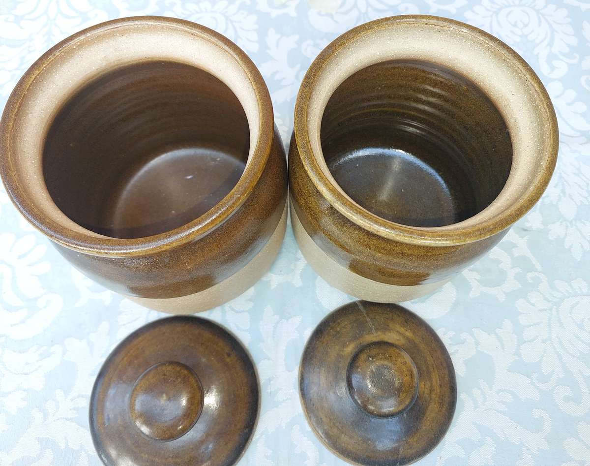 A PAIR OF STONEWARE STORAGE JARS SOLD AS IS