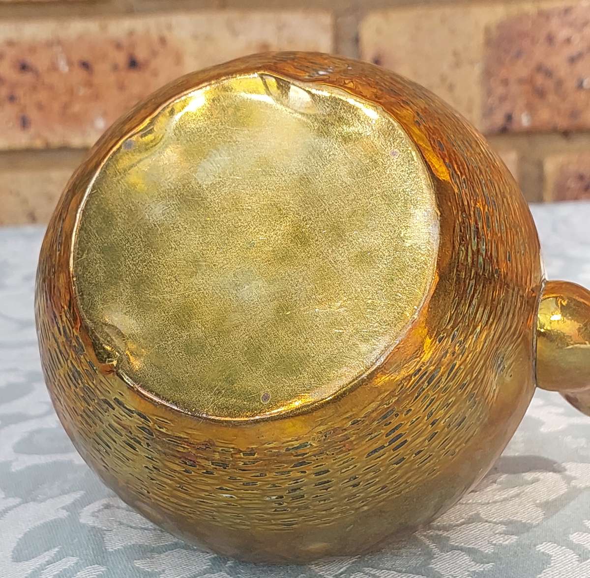 A VINTAGE BRASS TEAPOT SOLD AS IS