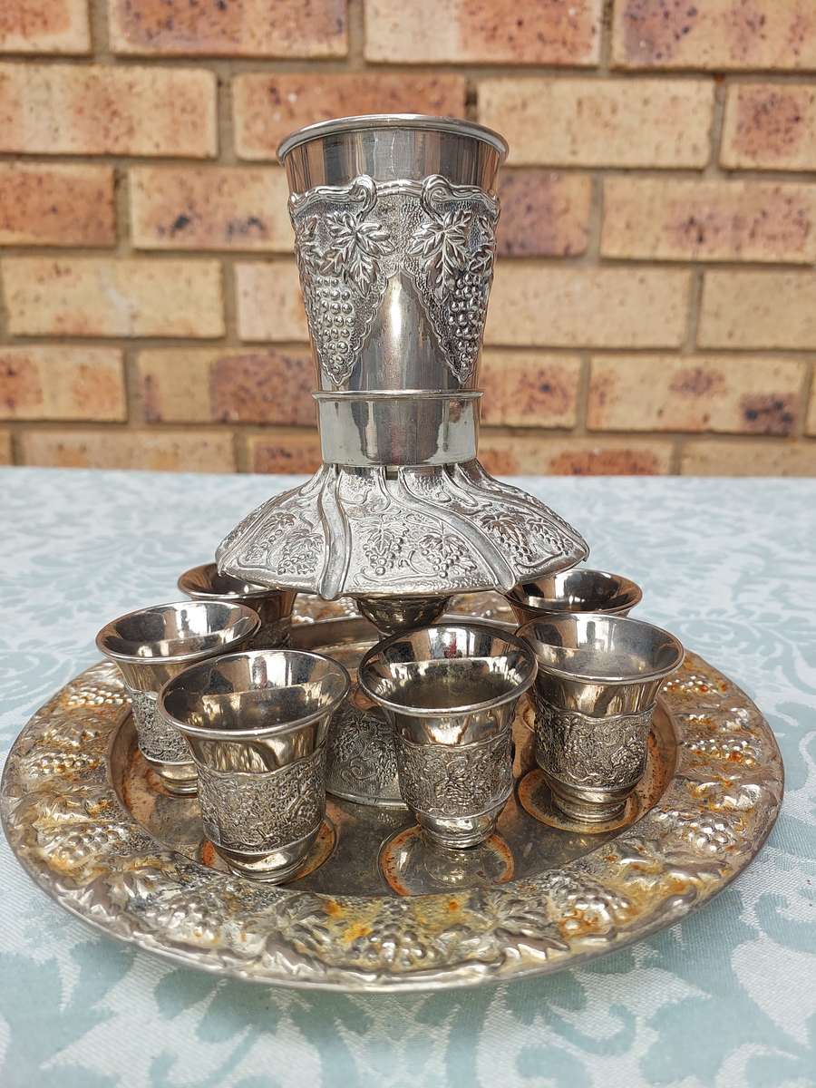 A VINTAGE KIDDUSH SET WITH 2 CUPS MISSING SOLD AS IS