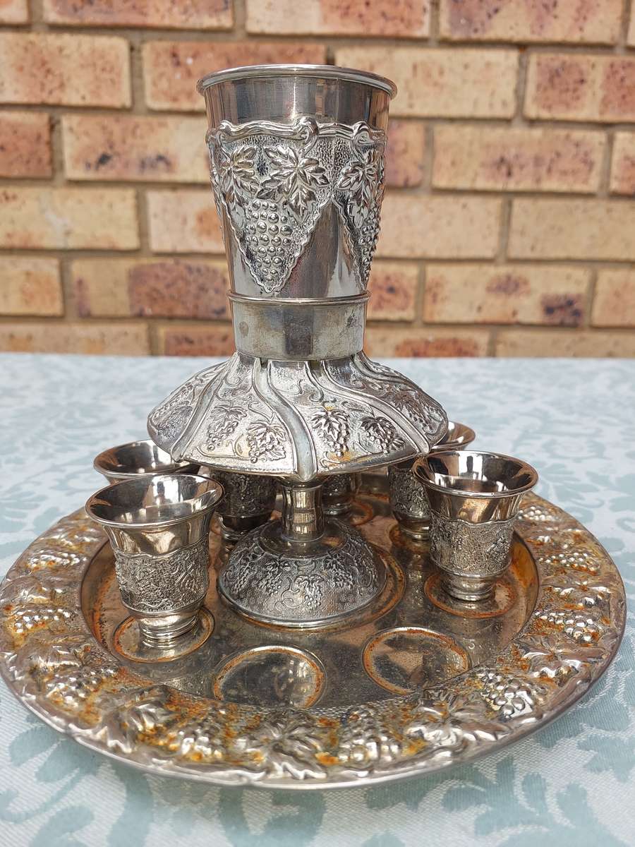 A VINTAGE KIDDUSH SET WITH 2 CUPS MISSING SOLD AS IS