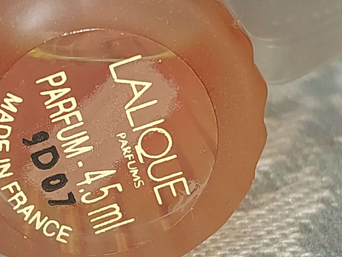 A COLLECTION OF MINITURE LALIQUE PERFUME BOTTLES AND SOME HAVE PERFUMES IN IT SOLD AS IS