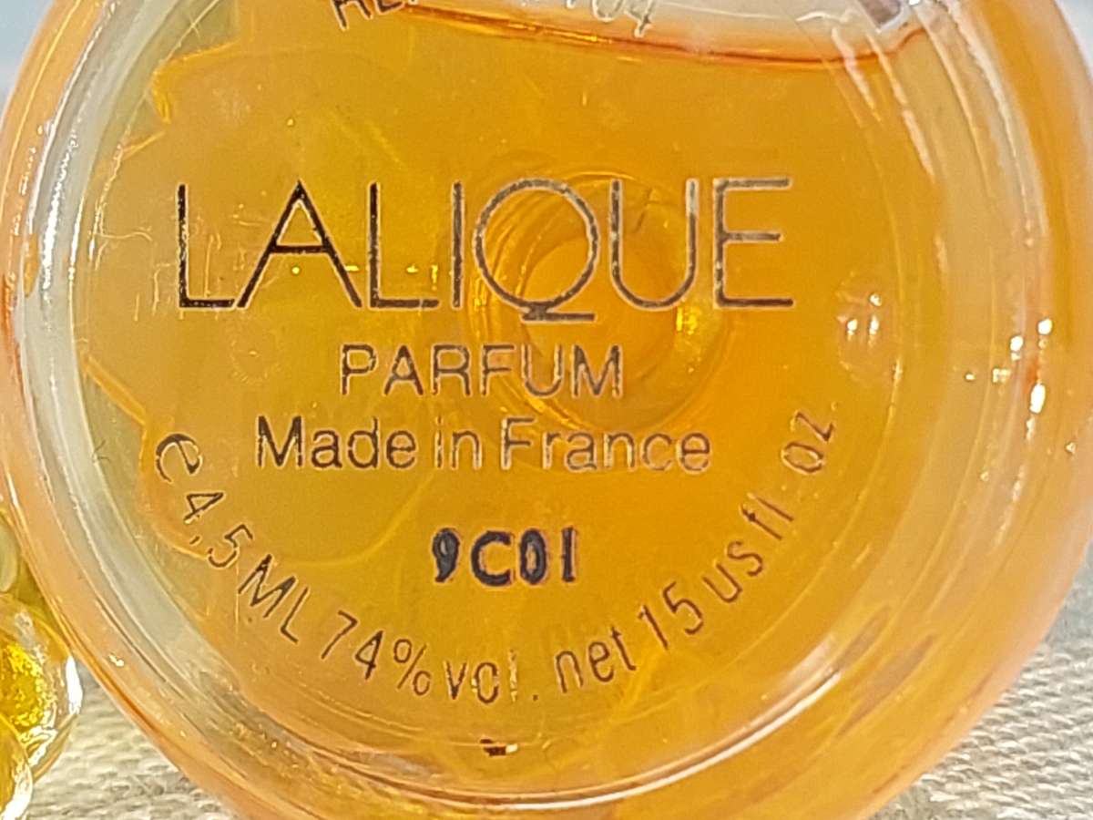 A COLLECTION OF MINITURE LALIQUE PERFUME BOTTLES AND SOME HAVE PERFUMES IN IT SOLD AS IS