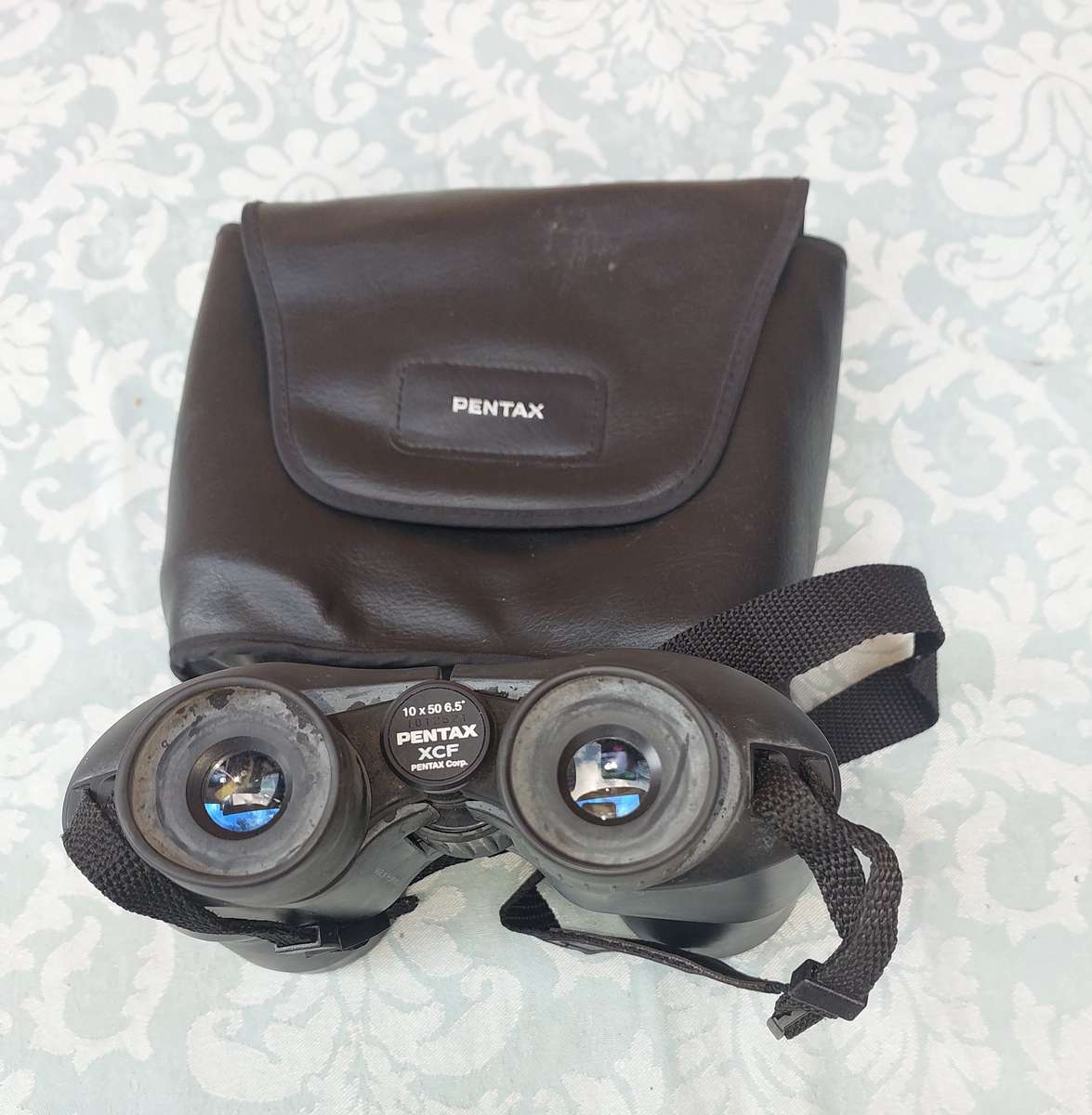 A USED PENTAX 10X50  6.5 XCF BINOCULARS SOLD AS IS