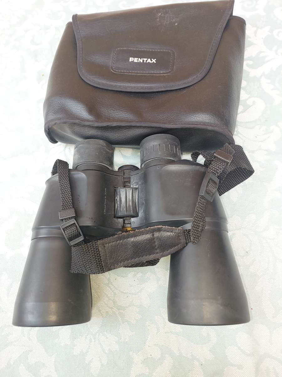 A USED PENTAX 10X50  6.5 XCF BINOCULARS SOLD AS IS