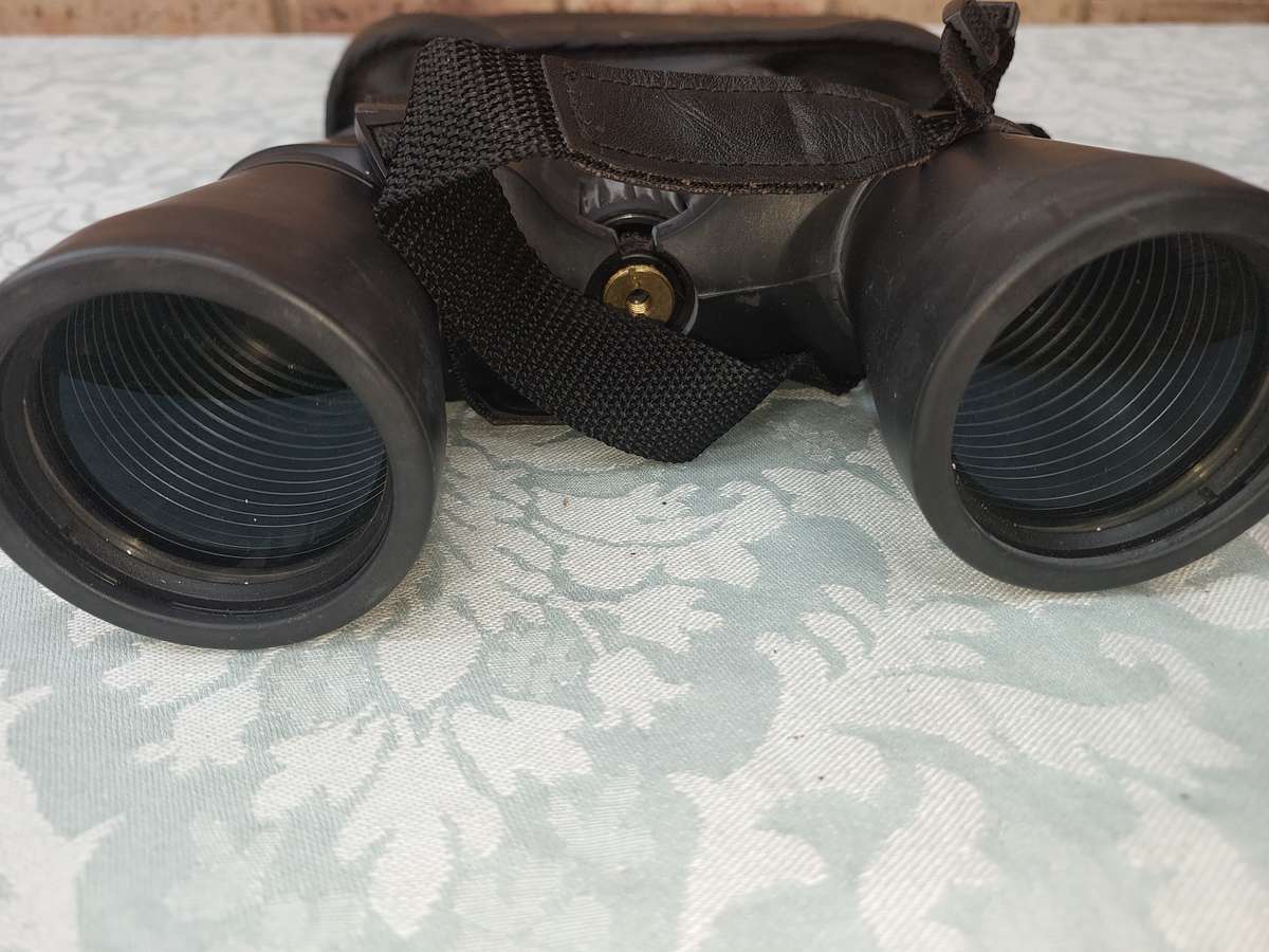 A USED PENTAX 10X50  6.5 XCF BINOCULARS SOLD AS IS