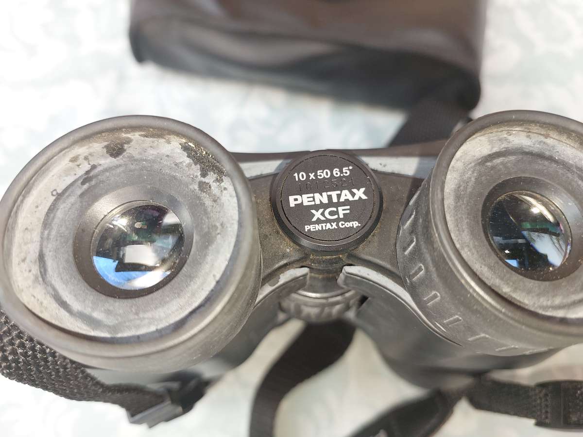A USED PENTAX 10X50  6.5 XCF BINOCULARS SOLD AS IS