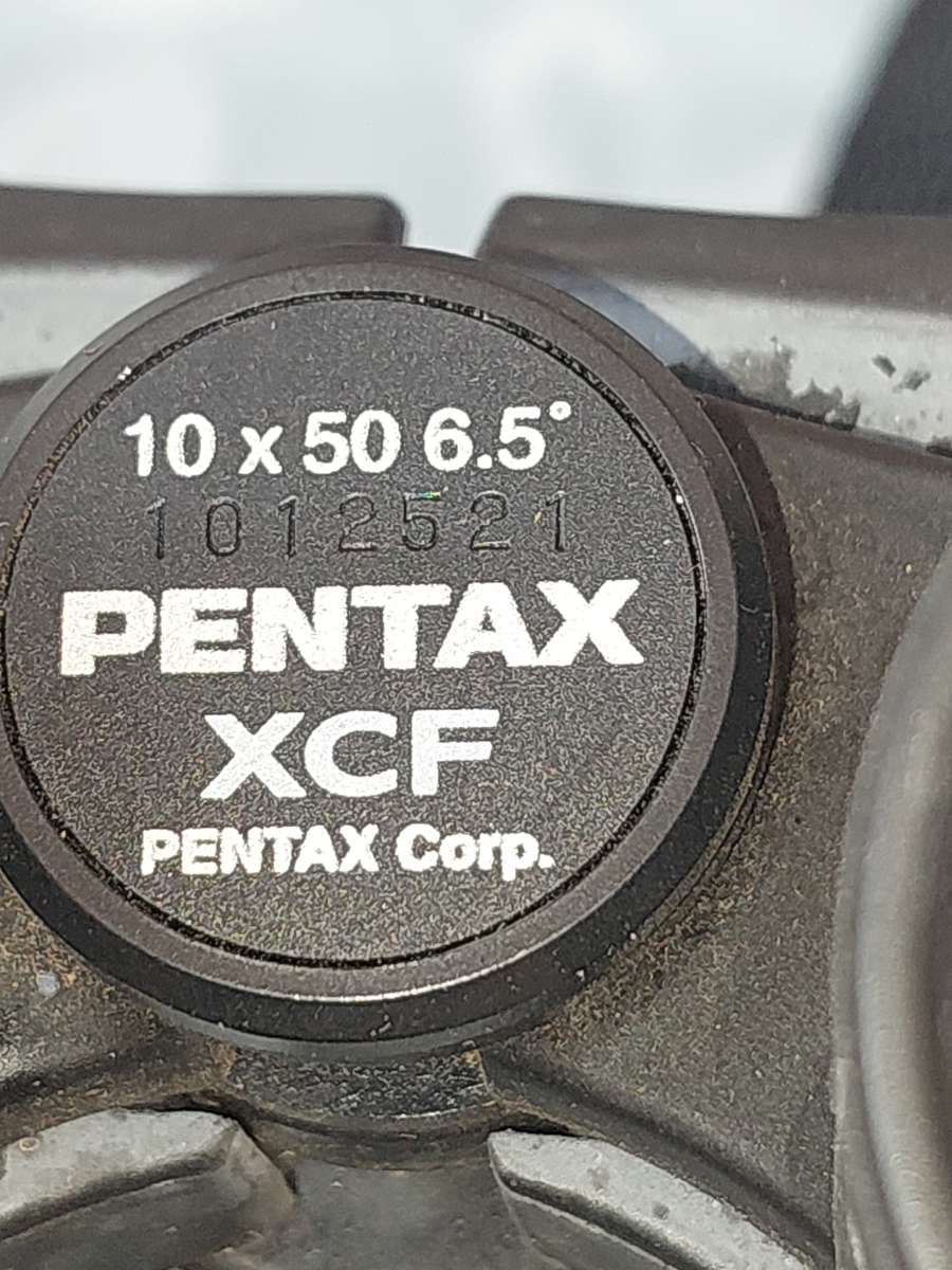 A USED PENTAX 10X50  6.5 XCF BINOCULARS SOLD AS IS