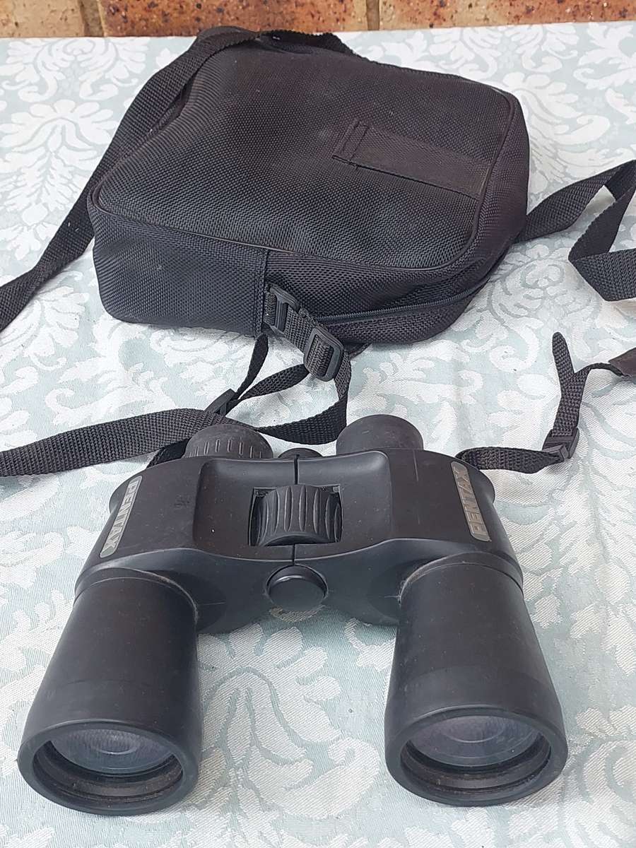 A USED PENTAX 10X50 BINOCULARS SOLD AS IS