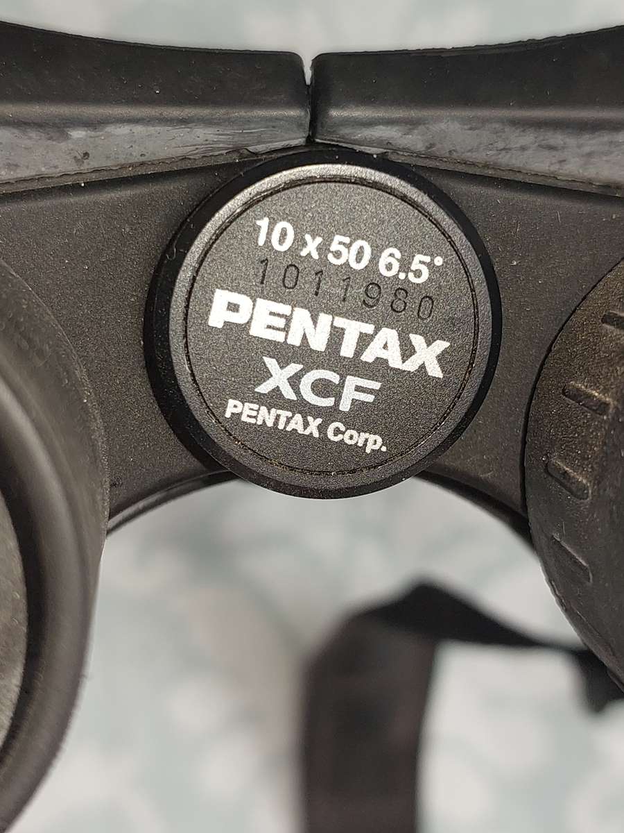 A USED PENTAX 10X50 BINOCULARS SOLD AS IS