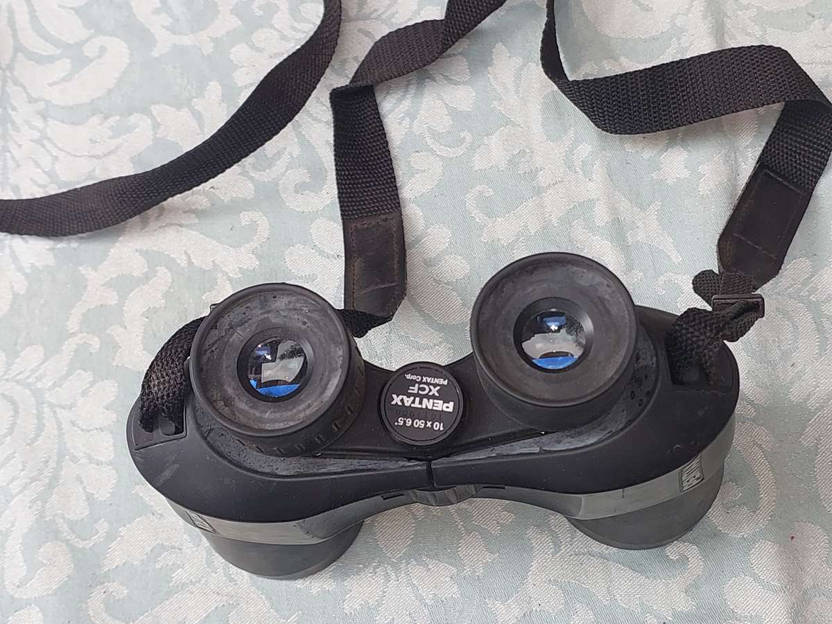 A USED PENTAX 10X50 BINOCULARS SOLD AS IS