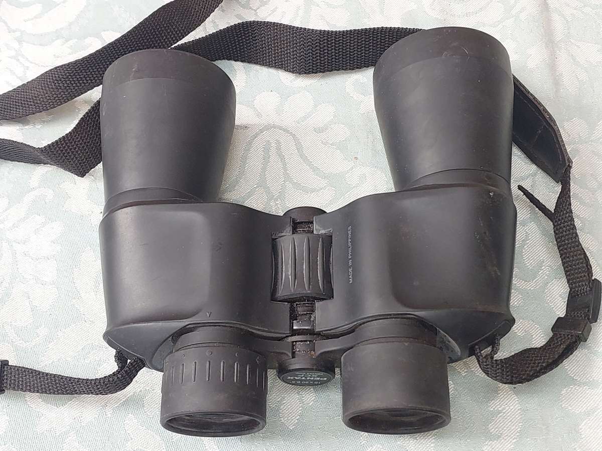 A USED PENTAX 10X50 BINOCULARS SOLD AS IS