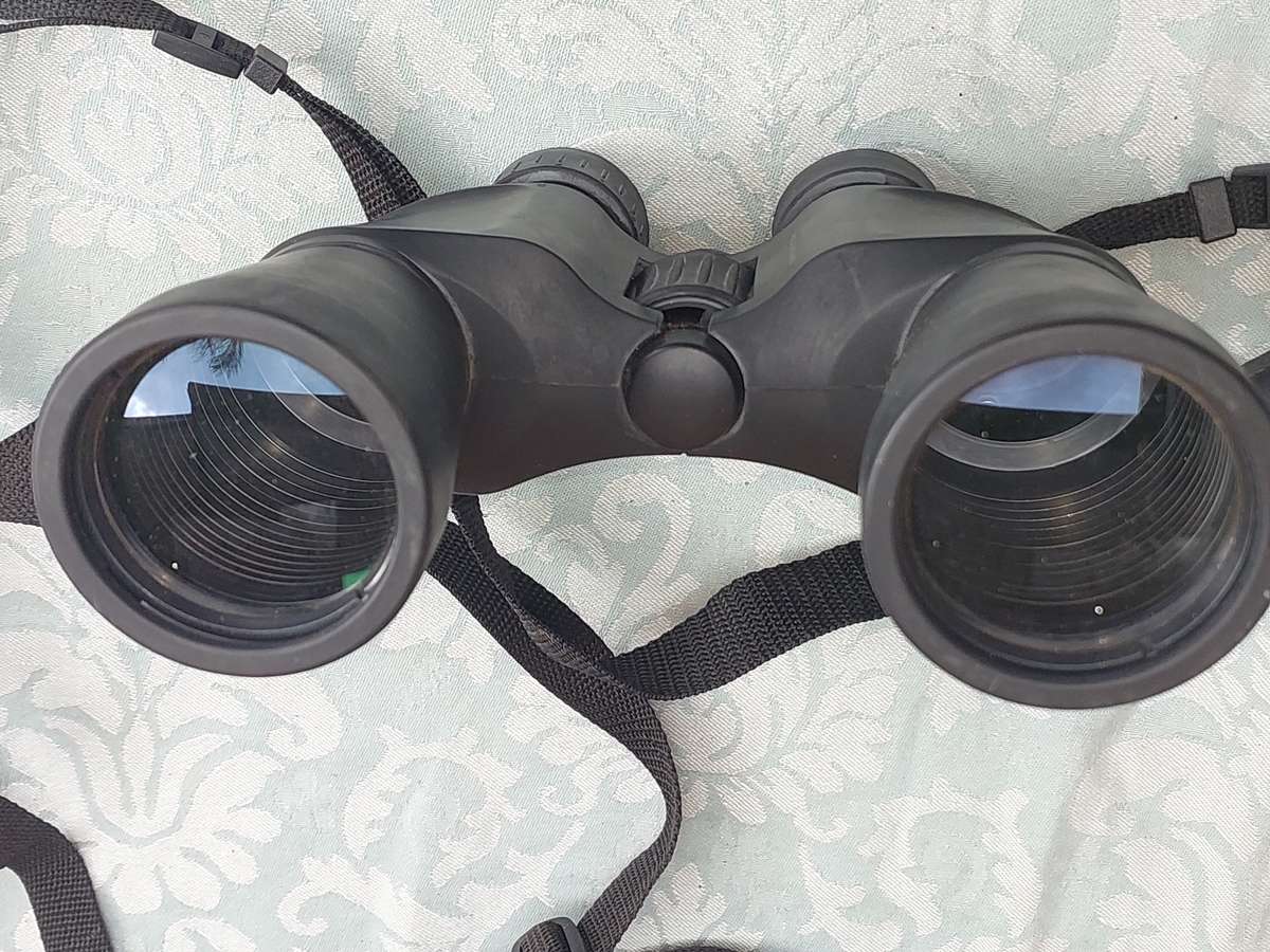 A USED PENTAX 10X50 BINOCULARS SOLD AS IS