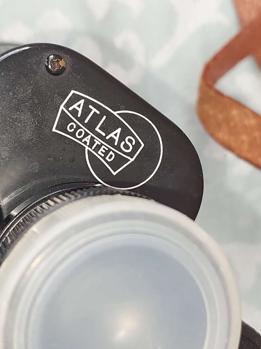 A VINTAGE ATLAS 8X30MM BINOCULARS SOLD AS IS