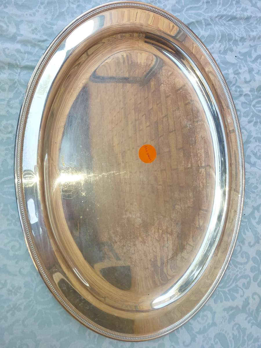 A VINTAGE SILVER PLATED OVAL SERVING TRAY SOLD AS IS