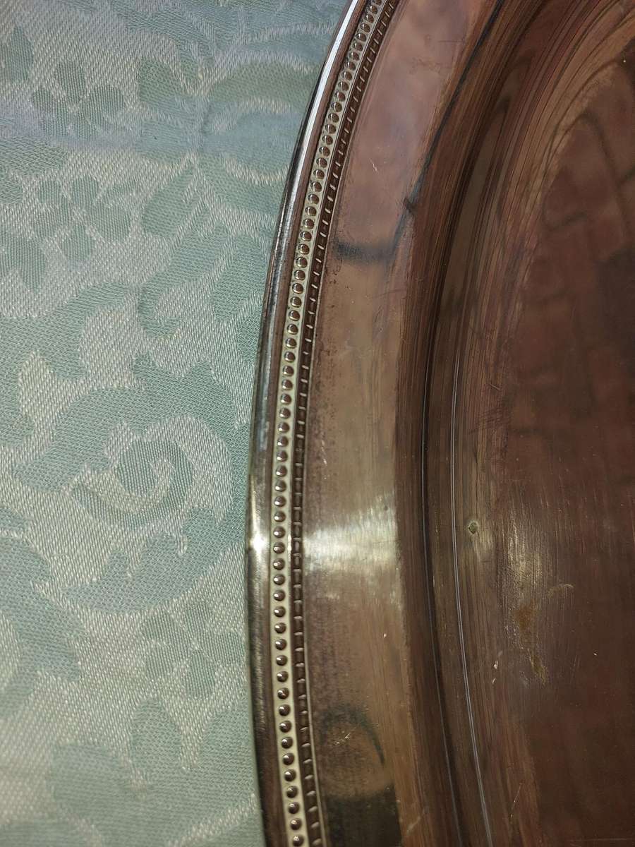 A VINTAGE SILVER PLATED OVAL SERVING TRAY SOLD AS IS