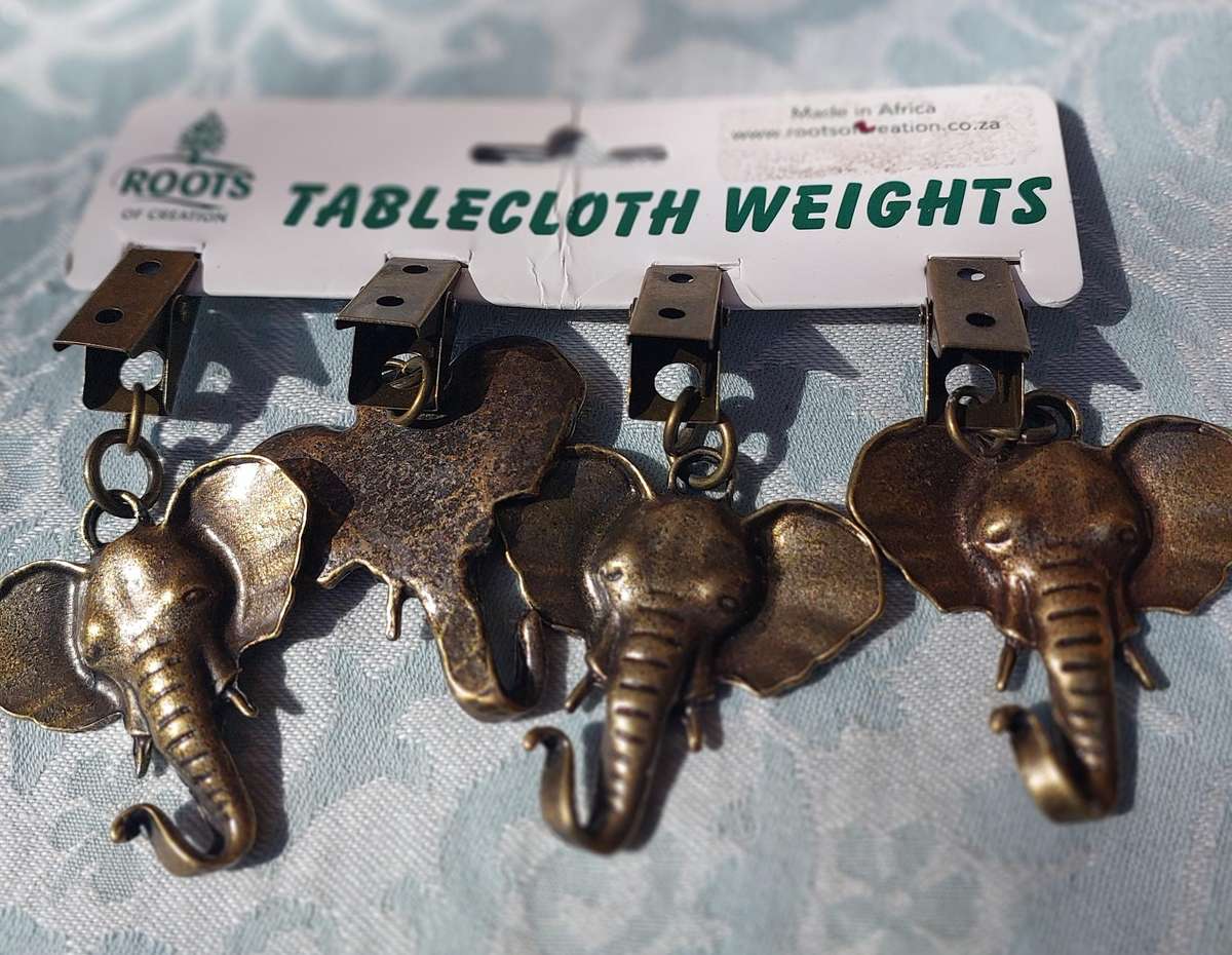 A SET OF ELEPHANT TABLE CLOTH WEIGHTS SOLD AS IS