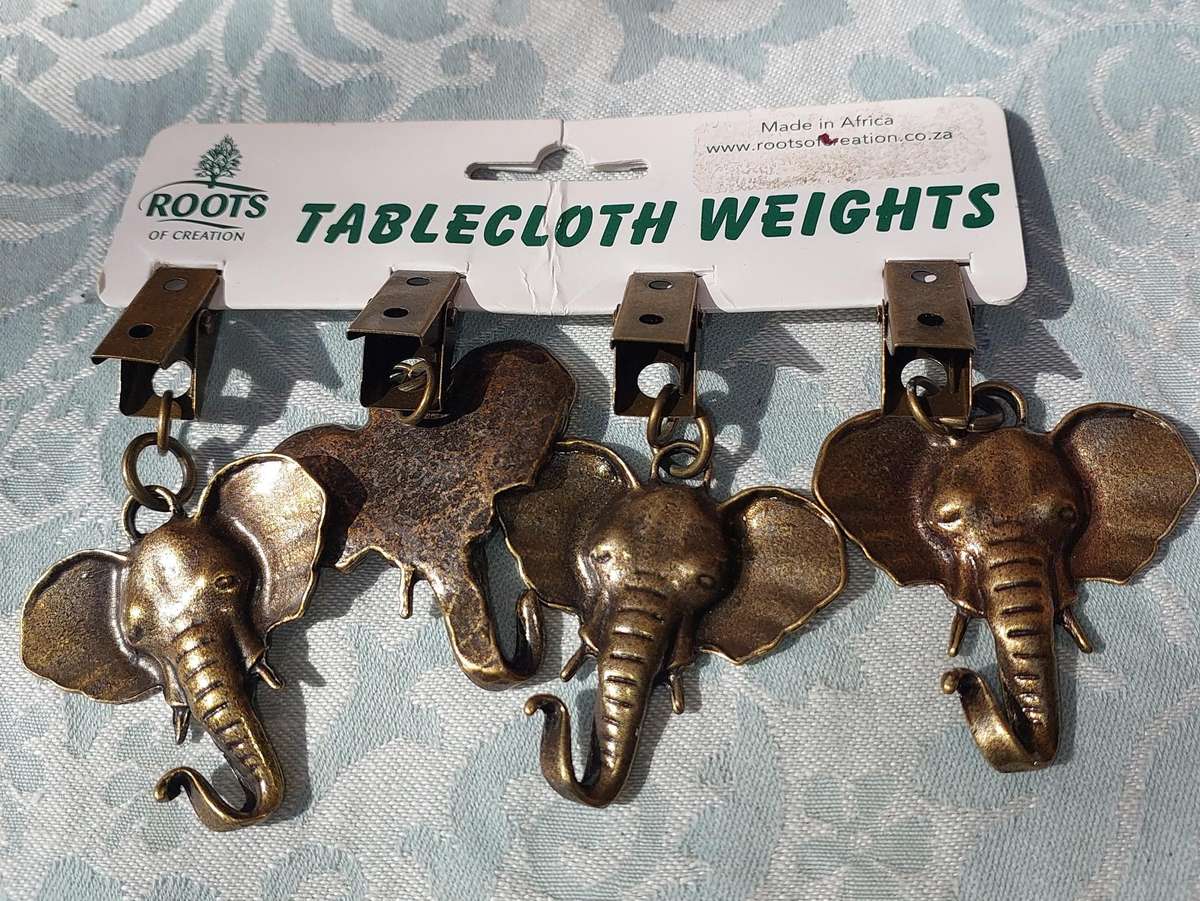 A SET OF ELEPHANT TABLE CLOTH WEIGHTS SOLD AS IS