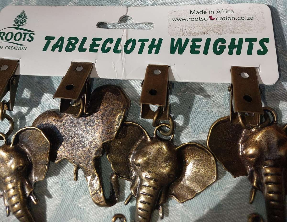 A SET OF ELEPHANT TABLE CLOTH WEIGHTS SOLD AS IS