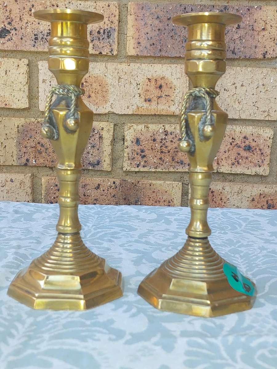 A VINTAGE PAIR OF VICTORIAN BRASS CANDLE HOLDER SOLD AS IS