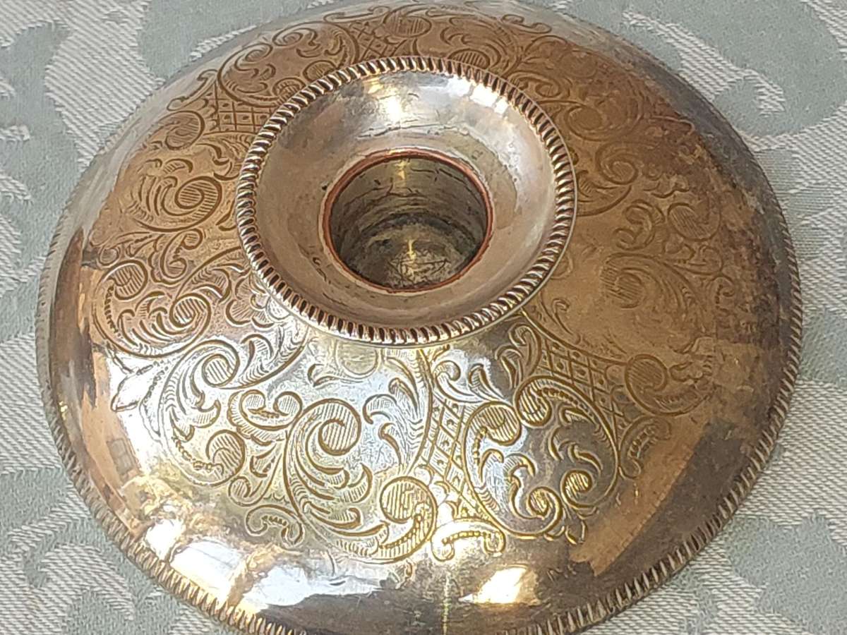 A PAIR OF SILVER PLATE ENGLAND CANDLE HOLDERS WITH ART WORK ENGRAVINGS SOLD AS IS