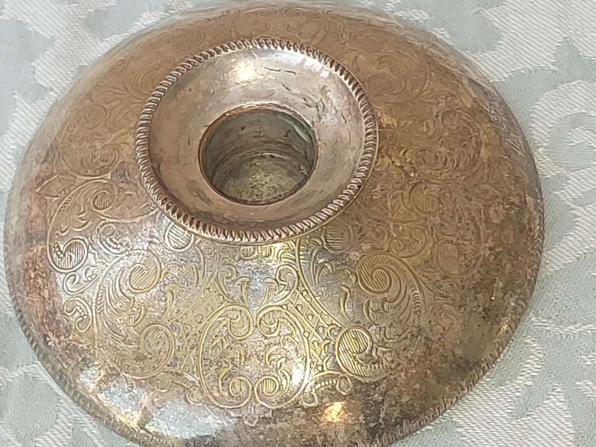 A PAIR OF SILVER PLATE ENGLAND CANDLE HOLDERS WITH ART WORK ENGRAVINGS SOLD AS IS